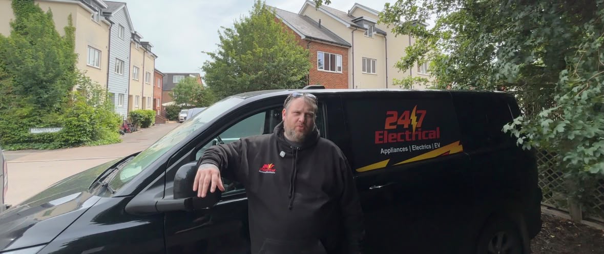 Steve from 24/7 Electrical next to the company van on a residential job
