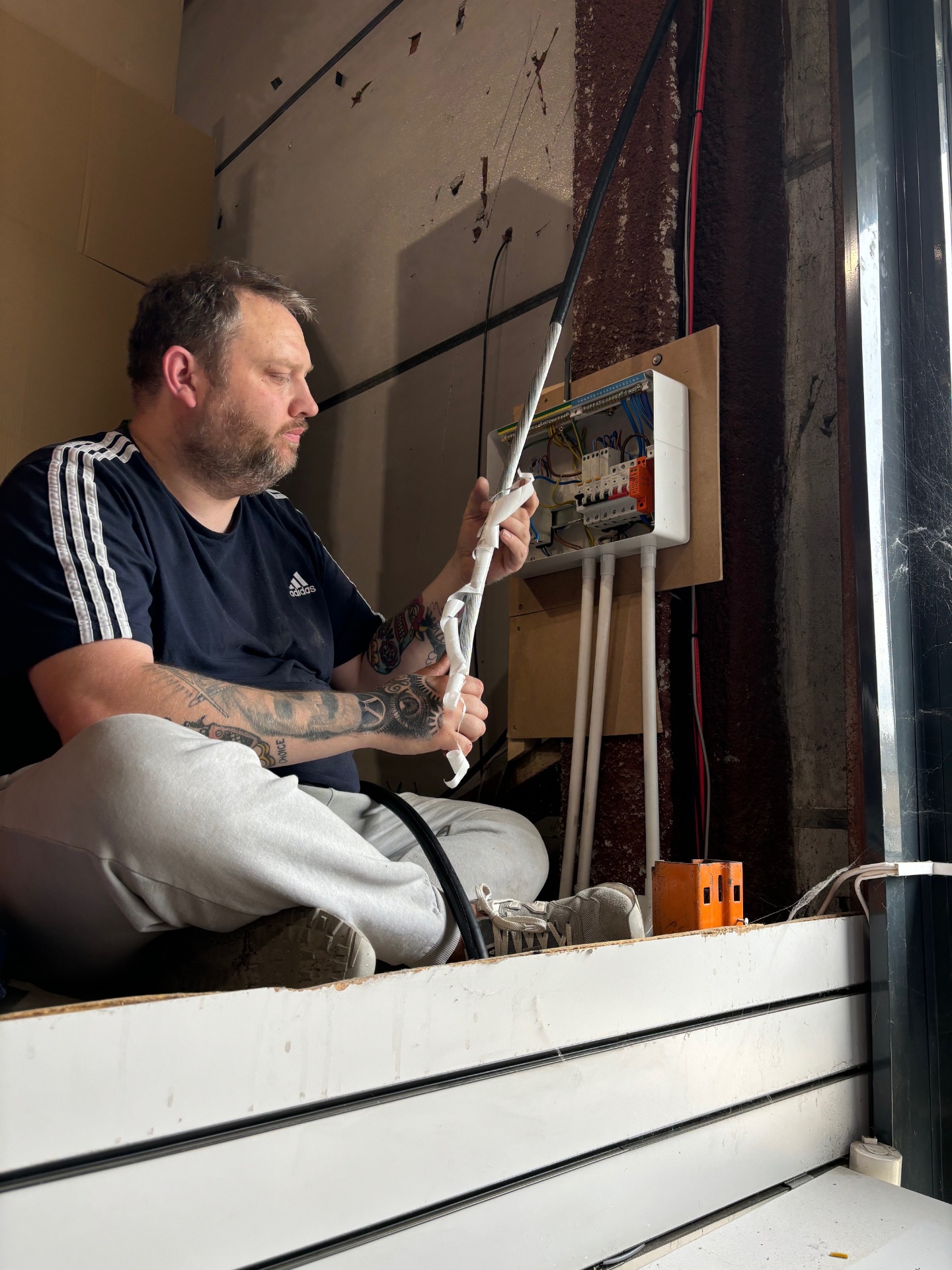 Engineer routing cables through building structure